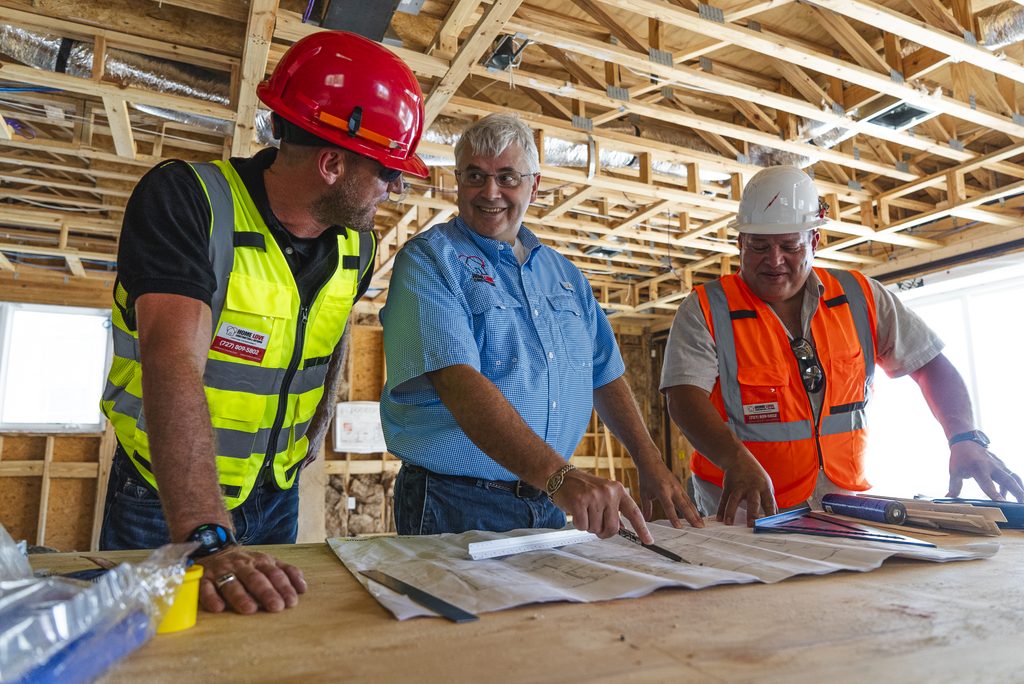 Contractor reviewing renovation plans during a home remodeling inspection